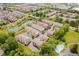Aerial view of community featuring townhouses, a pond with fountains, green spaces, and a swimming pool at 11872 Salerno Ct, Carmel, IN 46032