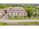 An aerial view of townhomes in a well landscaped and maintained suburban neighborhood along a paved street at 11872 Salerno Ct, Carmel, IN 46032