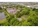 Expansive aerial view of brick townhomes, water features and lush green trees in a suburban neighborhood at 11872 Salerno Ct, Carmel, IN 46032
