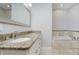 Bright bathroom with double sinks, granite countertop and large mirror at 11872 Salerno Ct, Carmel, IN 46032
