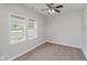 Bedroom with plush carpet, two windows, neutral walls, and a ceiling fan at 11872 Salerno Ct, Carmel, IN 46032