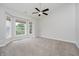 Bright bedroom with vaulted ceiling, neutral carpet, large windows and ceiling fan at 11872 Salerno Ct, Carmel, IN 46032