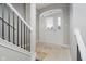 Inviting entryway with white walls, tile flooring, a staircase, and a door with sidelights at 11872 Salerno Ct, Carmel, IN 46032