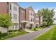 Charming brick townhomes featuring well-kept lawns and stone accents along a sidewalk at 11872 Salerno Ct, Carmel, IN 46032