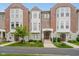 Charming townhouse exterior featuring a brick facade, bay windows, landscaped front yard, and welcoming entryway at 11872 Salerno Ct, Carmel, IN 46032