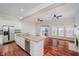 Open kitchen featuring an island with a sink, stainless steel appliances, and hardwood floors at 11872 Salerno Ct, Carmel, IN 46032