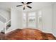 Bright living room featuring hardwood floors, large windows and a ceiling fan at 11872 Salerno Ct, Carmel, IN 46032