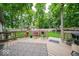 A backyard featuring a deck with an outdoor rug, flower planters and mature trees at 1304 Old Hickory Cir, Greenwood, IN 46142