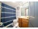 This bathroom features a toilet, vanity, sink, mirror, and shower with curtain at 1304 Old Hickory Cir, Greenwood, IN 46142