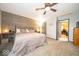 This bedroom features a wood paneled wall, neutral paint, and lots of natural light at 1304 Old Hickory Cir, Greenwood, IN 46142