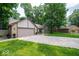 Ranch-style home with a spacious driveway, attached garage, and lush green lawn at 1304 Old Hickory Cir, Greenwood, IN 46142