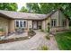 Inviting front entrance with a stone accent wall and manicured flower beds at 1304 Old Hickory Cir, Greenwood, IN 46142