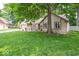 Well-maintained ranch home with a stone facade, mature trees, and green lawn at 1304 Old Hickory Cir, Greenwood, IN 46142