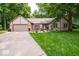 Charming single-story home featuring a well-manicured lawn and stone facade at 1304 Old Hickory Cir, Greenwood, IN 46142