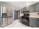 This kitchen features stainless steel appliances and white countertops at 1304 Old Hickory Cir, Greenwood, IN 46142