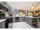 Bright kitchen features gray cabinets, stainless steel appliances, and a center island for dining at 1304 Old Hickory Cir, Greenwood, IN 46142
