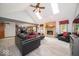 Open-concept living room featuring a stone fireplace, skylights, and gray flooring at 1304 Old Hickory Cir, Greenwood, IN 46142
