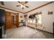 Home office features a ceiling fan, wood trim, and built-in desk near the window at 1304 Old Hickory Cir, Greenwood, IN 46142