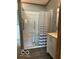 Bathroom with accessible shower, white vanity, and wood-look floors at 135 Sunset Ct, Cicero, IN 46034