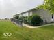 Ranch home featuring a wheelchair ramp, neat landscaping, and two patio chairs at 135 Sunset Ct, Cicero, IN 46034
