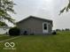 Side view of a well-maintained ranch home featuring a grassy lawn at 135 Sunset Ct, Cicero, IN 46034