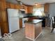 Kitchen with light wood cabinets, island, and white appliances at 135 Sunset Ct, Cicero, IN 46034