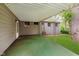 A view of the covered patio with a green painted floor and back yard at 1410 Lawrence Ave, Indianapolis, IN 46227