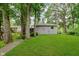 A spacious backyard with mature trees and a walking path at 1410 Lawrence Ave, Indianapolis, IN 46227