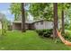 Backyard featuring mature trees and a covered patio at 1410 Lawrence Ave, Indianapolis, IN 46227