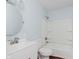 Clean bathroom with a white vanity, toilet, and shower-tub combo, highlighted by light blue walls at 1410 Lawrence Ave, Indianapolis, IN 46227