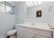 Bathroom with blue walls, a white vanity, and a window with natural light at 1410 Lawrence Ave, Indianapolis, IN 46227