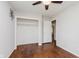 Bedroom featuring hardwood floors, ceiling fan, neutral walls, and a closet for optimal storage at 1410 Lawrence Ave, Indianapolis, IN 46227