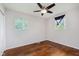 Bedroom featuring hardwood floors, ceiling fan, neutral walls, and dual windows for natural light at 1410 Lawrence Ave, Indianapolis, IN 46227