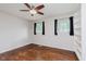 Bedroom featuring hardwood floors, ceiling fan, neutral walls, and built in book shelves at 1410 Lawrence Ave, Indianapolis, IN 46227