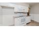 Practical kitchen featuring white cabinets, stone countertops, and modern appliances at 1410 Lawrence Ave, Indianapolis, IN 46227