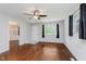 Bright living room with hardwood floors, a ceiling fan, and plenty of natural light from the windows at 1410 Lawrence Ave, Indianapolis, IN 46227