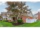 View of the home's exterior, featuring a fenced yard and a tree providing shade, perfect for outdoor relaxation at 15528 Bowie Dr, Westfield, IN 46074