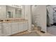 This bathroom features double sinks, a full mirror, and a shower behind a glass door at 15528 Bowie Dr, Westfield, IN 46074