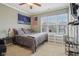 Bedroom with a neutral color scheme, ceiling fan, and a large window for ample natural light at 15528 Bowie Dr, Westfield, IN 46074