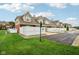 View of townhome community featuring manicured lawns, driveways, and fenced yards at 15528 Bowie Dr, Westfield, IN 46074