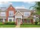 Charming townhome showcases a mix of brick and siding, complemented by a well-manicured lawn and inviting front porch at 15528 Bowie Dr, Westfield, IN 46074