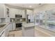 Bright kitchen with gray cabinets, stainless steel appliances, granite countertops, and a functional kitchen island at 15528 Bowie Dr, Westfield, IN 46074