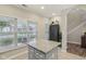 Bright eat-in kitchen with a kitchen island, hardwood floors, and a view of the staircase at 15528 Bowie Dr, Westfield, IN 46074