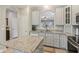 Open-concept kitchen featuring granite countertops, stainless steel appliances, light gray cabinets and a functional kitchen island at 15528 Bowie Dr, Westfield, IN 46074