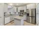 Kitchen featuring stainless steel appliances, granite countertops, light gray cabinets, and a functional kitchen island at 15528 Bowie Dr, Westfield, IN 46074