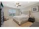 This main bedroom features a large window, a plush bed, and an accent chair at 15528 Bowie Dr, Westfield, IN 46074