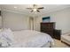 This main bedroom features a plush bed, dark wood dresser, and a ceiling fan at 15528 Bowie Dr, Westfield, IN 46074