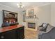 A spacious office that is well-lit with a fireplace and built-in bookshelves at 15528 Bowie Dr, Westfield, IN 46074