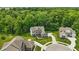 Aerial view of home with manicured lawn surrounded by many green trees and other homes at 16244 Perrault Ct, Fishers, IN 46040