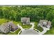 Aerial view of home and lawns nestled in green trees and well maintained landscaping at 16244 Perrault Ct, Fishers, IN 46040